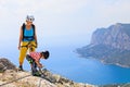 Mother, child in safety equipment climb by via ferrata route