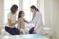 Friendly doctor listening to little patient& x27;s breath or heartbeat during medical checkup Royalty Free Stock Photo