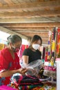 mother and child are selling traditional clothes of the Dayak Tunjung tribe