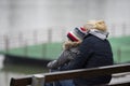 A mother with a child is sitting on a bench Royalty Free Stock Photo