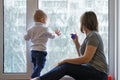 Mother and child are sitting on windowsill Royalty Free Stock Photo