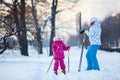 Mother and child on ski in city park Royalty Free Stock Photo