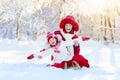 Mother and child sledding. Winter snow fun. Family on sleigh. Royalty Free Stock Photo