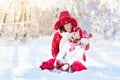 Mother and child sledding. Winter snow fun. Family on sleigh. Royalty Free Stock Photo