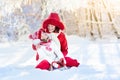 Mother and child sledding. Winter snow fun. Family on sleigh. Royalty Free Stock Photo