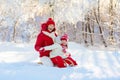 Mother and child sledding. Winter snow fun. Family on sleigh Royalty Free Stock Photo