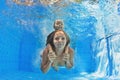 Mother with child swimming and diving underwater in pool Royalty Free Stock Photo