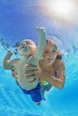 Mother with child swimming and diving underwater in pool Royalty Free Stock Photo