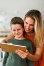 Mother and child using digital tablet for e-learning. Education home digital device kid concept. Royalty Free Stock Photo