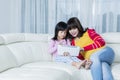 Mother and child using a tablet together at home Royalty Free Stock Photo