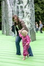 A mother and child walk on inflatable Stonehenge