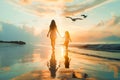 A mother and child walking on the beach at sunset. Royalty Free Stock Photo