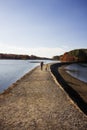 Mother and child walking on a path by the ocean