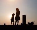 Mother and child are walking together in fun in love at sunset Royalty Free Stock Photo