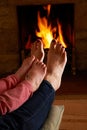 Mother And Child Warming Feet By Fire