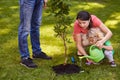 Mother and child watering tree