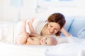 Mother and baby on a white bed Royalty Free Stock Photo