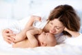 Baby and mother at home in bed. Mom and child. Royalty Free Stock Photo