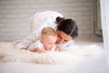 Mother and child in a white room. Mom and baby boy in diaper pla Royalty Free Stock Photo