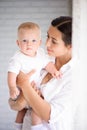 Mother and child in a white room. Mom and baby boy in diaper pla Royalty Free Stock Photo