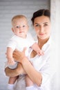 Mother and child in a white room. Mom and baby boy in diaper pla Royalty Free Stock Photo