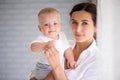 Mother and child in a white room. Mom and baby boy in diaper pla Royalty Free Stock Photo