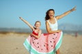 Mother and child wrapped in funny watermelon towel rejoicing