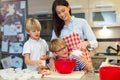 Mother and children baking together Royalty Free Stock Photo
