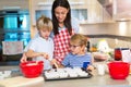 Mother and children baking together Royalty Free Stock Photo