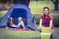 Mother and children camping in the park