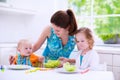 Mother and children cooking in a white kitchen Royalty Free Stock Photo