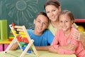 Mother with children counting with abacus