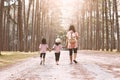 Mother and children daughter holding hand and walking together