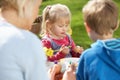 Mother And Children Decorating Easter Eggs