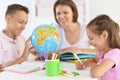 Mother with children doing homework at home