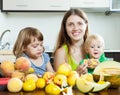 Mother with children eating melon and other fruits Royalty Free Stock Photo