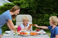 Mother with children eating outdoors