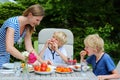 Mother with children eating outdoors