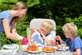 Mother with children eating outdoors