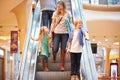 Mother And Children On Escalator In Shopping Mall Royalty Free Stock Photo