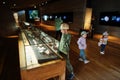 Mother with children exploring expositions in museum halls