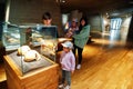 Mother with children exploring skulls humans evolution at museum