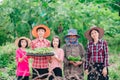 Mother and children family holding seeding plants to planting tree on blurred green nature background Royalty Free Stock Photo