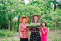 Mother and children family holding seeding plants to planting tree on blurred green nature background Royalty Free Stock Photo