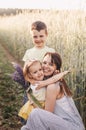 Mother with children with her son and daughter walking through a field of wheat Royalty Free Stock Photo