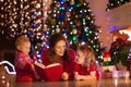 Mother and children at home on Christmas eve Royalty Free Stock Photo