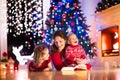 Mother and children at home on Christmas eve Royalty Free Stock Photo