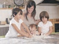 Mother and children kneading the cake dough