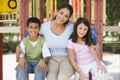 Mother and children in playground Royalty Free Stock Photo