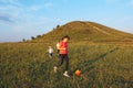 Mother with children playing with ball at hill with cross